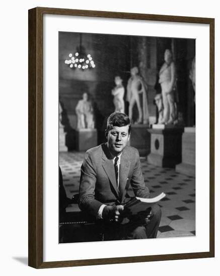 Senator John F. Kennedy Seated in Museum with Statues-Hank Walker-Framed Photographic Print