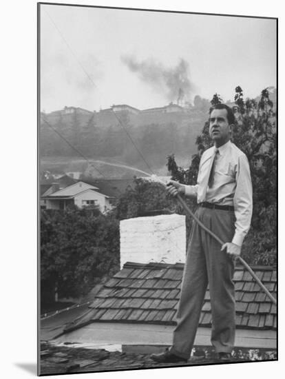 Senator Richard M. Nixon on Roof of Home in Los Angeles, Putting Out Fires Caused by Brush Blaze-Allan Grant-Mounted Photographic Print