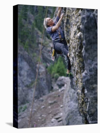 Senior Man Rock Climbing-null-Stretched Canvas