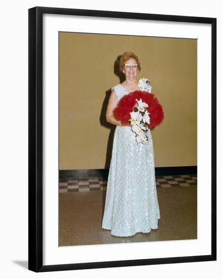 Senior Woman with Bouquet Poses Against Wall, Ca. 1970-null-Framed Photographic Print