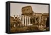 Sepia image of columns of the Forum and Colosseum or Roman Coliseum at dusk with streaked car li...-null-Framed Stretched Canvas