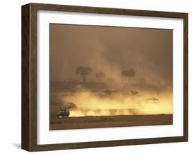 Setting Sun Lights Cloud of Dust, Masai Mara Game Reserve, Kenya-Paul Souders-Framed Photographic Print