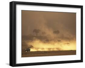 Setting Sun Lights Cloud of Dust, Masai Mara Game Reserve, Kenya-Paul Souders-Framed Photographic Print