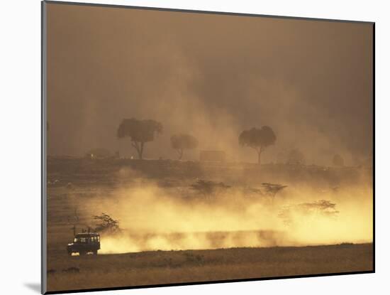 Setting Sun Lights Cloud of Dust, Masai Mara Game Reserve, Kenya-Paul Souders-Mounted Photographic Print