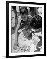 Settlement House Children Burying Boy under Sand at the Beach-Martha Holmes-Framed Photographic Print