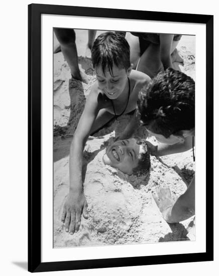 Settlement House Children Burying Boy under Sand at the Beach-Martha Holmes-Framed Photographic Print