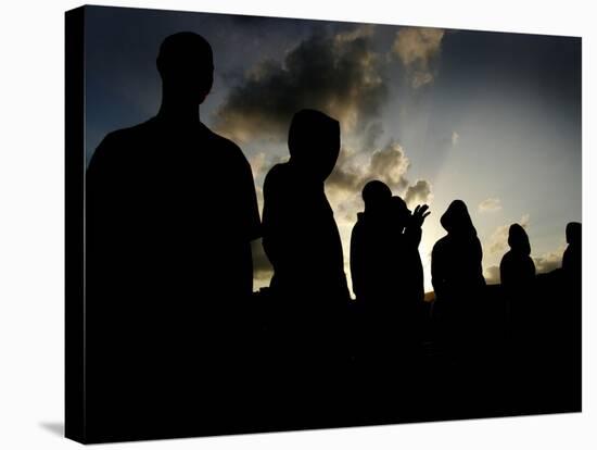 Several Africans Immigrants Chat at Sunset Outside of the Holding Centre for Immigrants-null-Stretched Canvas