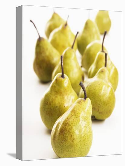 Several Pears Standing One Behind the Other-Dieter Heinemann-Stretched Canvas