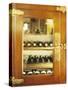 Several Wine Bottles in Wood-Panelled Drinks Cabinet-Peter Medilek-Stretched Canvas