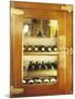 Several Wine Bottles in Wood-Panelled Drinks Cabinet-Peter Medilek-Mounted Photographic Print