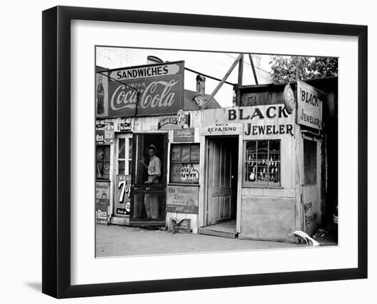 Shack Like Black Jeweler Shop Next to Food Store Covered with Ads in a Slum Section of the City.-Alfred Eisenstaedt-Framed Photographic Print