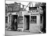 Shack Like Black Jeweler Shop Next to Food Store Covered with Ads in a Slum Section of the City.-Alfred Eisenstaedt-Mounted Photographic Print
