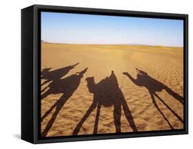 Shadows of people riding camels in a caravan in Zagora Desert, Draa-Tafilalet Region, Morocco-Karol Kozlowski-Framed Stretched Canvas