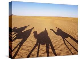 Shadows of people riding camels in a caravan in Zagora Desert, Draa-Tafilalet Region, Morocco-Karol Kozlowski-Stretched Canvas