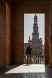 Man enjoying the view of Plaza de Espana, framed through an archway, Seville, Andalusia, Spain-Shanna Baker-Photographic Print