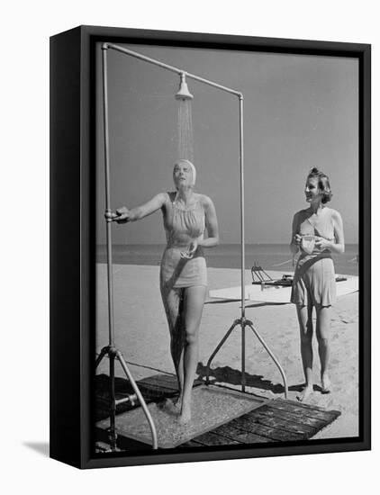 Shapely Sunbather Taking an Outdoor Shower as Woman Preparing for Her Turn, Looks On, at Beach-Alfred Eisenstaedt-Framed Stretched Canvas