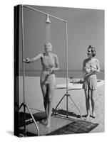 Shapely Sunbather Taking an Outdoor Shower as Woman Preparing for Her Turn, Looks On, at Beach-Alfred Eisenstaedt-Stretched Canvas