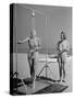 Shapely Sunbather Taking an Outdoor Shower as Woman Preparing for Her Turn, Looks On, at Beach-Alfred Eisenstaedt-Stretched Canvas