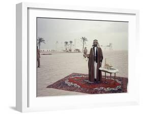 Sheik Shakbut Bin Sultan Al Nahyan Standing in Front of His Palace Holding a Falcon, 1963-Ralph Crane-Framed Photographic Print