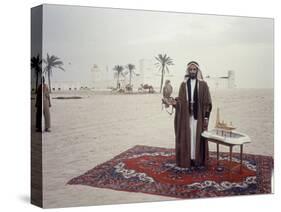 Sheik Shakbut Bin Sultan Al Nahyan Standing in Front of His Palace Holding a Falcon, 1963-Ralph Crane-Stretched Canvas