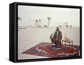 Sheikh Shakhbut Bin Sultan Al Nahyan Sitting in Front of His Palace Holding a Falcon, 1963-Ralph Crane-Framed Stretched Canvas