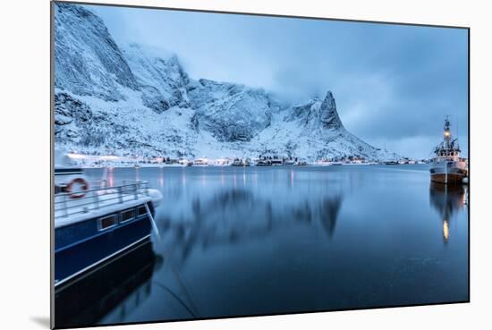 Ships Moored in the Small Harbor of Reine under a Gloomy Sky in the South of the Lofoten Islands-Roberto Moiola-Mounted Photographic Print