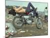 Shirtless Man in Levi Strauss Jeans Lying on Motorcycle Seat at Woodstock Music Festival-Bill Eppridge-Mounted Photographic Print