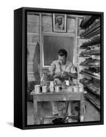 Shoemaker Sitting in His Shop Working on a Pair of Old Work Shoes-John Phillips-Framed Stretched Canvas