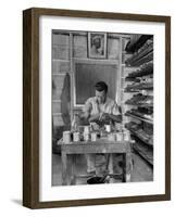 Shoemaker Sitting in His Shop Working on a Pair of Old Work Shoes-John Phillips-Framed Photographic Print