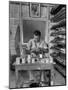 Shoemaker Sitting in His Shop Working on a Pair of Old Work Shoes-John Phillips-Mounted Photographic Print