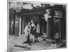 Shop Owner Poses with Two Mannequins Following the Destruction of His Shop by German Bombers-null-Mounted Photographic Print