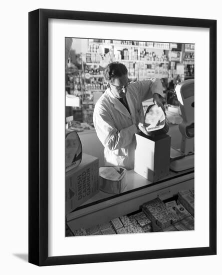 Shopkeeper Unpacking Canned Gammon Joints, Mexborough, South Yorkshire, 1963-Michael Walters-Framed Photographic Print