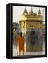 Shrine Guard in Orange Clothes Holding Lance Standing by Pool in Front of the Golden Temple-Eitan Simanor-Framed Stretched Canvas