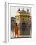 Shrine Guard in Orange Clothes Holding Lance Standing by Pool in Front of the Golden Temple-Eitan Simanor-Framed Photographic Print