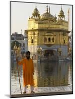 Shrine Guard in Orange Clothes Holding Lance Standing by Pool in Front of the Golden Temple-Eitan Simanor-Mounted Photographic Print