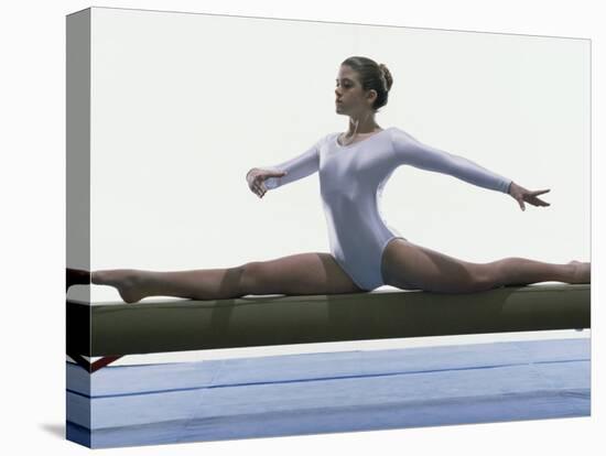Side Profile of a Female Gymnast Stretching on a Balance Beam-null-Stretched Canvas