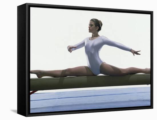 Side Profile of a Female Gymnast Stretching on a Balance Beam-null-Framed Stretched Canvas