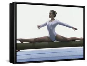 Side Profile of a Female Gymnast Stretching on a Balance Beam-null-Framed Stretched Canvas