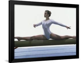 Side Profile of a Female Gymnast Stretching on a Balance Beam-null-Framed Photographic Print