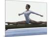 Side Profile of a Female Gymnast Stretching on a Balance Beam-null-Mounted Photographic Print