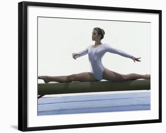 Side Profile of a Female Gymnast Stretching on a Balance Beam-null-Framed Photographic Print