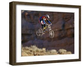 Side Profile of a Person on a Bicycle in Mid Air-null-Framed Premium Photographic Print