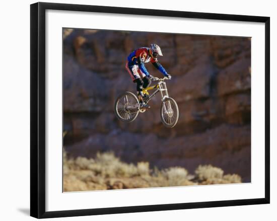 Side Profile of a Person on a Bicycle in Mid Air-null-Framed Photographic Print