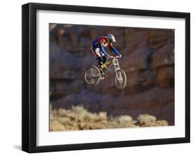 Side Profile of a Person on a Bicycle in Mid Air-null-Framed Photographic Print