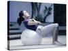 Side Profile of a Young Woman Exercising on a Fitness Ball-null-Stretched Canvas