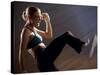 Side Profile of a Young Woman Kickboxing-null-Stretched Canvas