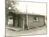 Side View of a Log Cabin Home-null-Mounted Photo