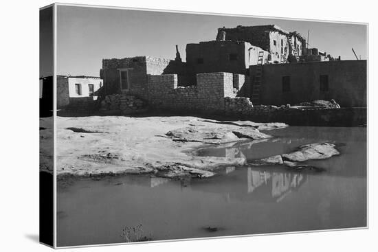 Side View Of Adobe House With Water In Foreground" Acoma Pueblo [NHL New Mexico]." 1933-1942-Ansel Adams-Stretched Canvas