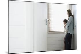 Side View of Mother and Daughter Looking Out of Window Blinds-Nosnibor137-Mounted Photographic Print