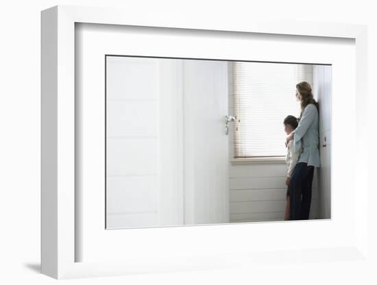 Side View of Mother and Daughter Looking Out of Window Blinds-Nosnibor137-Framed Photographic Print